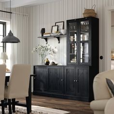 a dining room table with chairs and a china cabinet