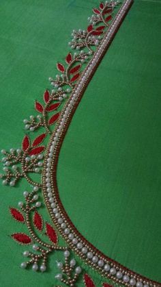 an embroidered green cloth with red and white beads