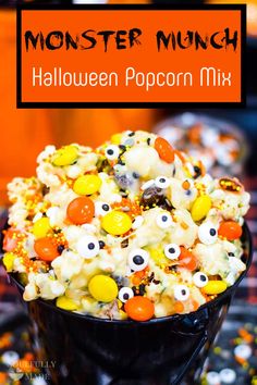 halloween popcorn mix in a black bowl with googly eyes and candy on the top