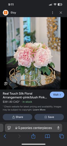 a vase with pink flowers sitting on top of a table next to an iphone screen