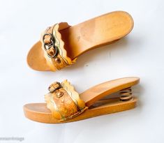 "~ 1970s fantastic wood sandals with spring heels ~ Gold & brown leather & plastic slides ~ Notice the spring heel ~ Rare wood shoes ~ Excellent Label:        Domo               Made in Italy Sole length- 9.5\"  (24.13 cm) Sole width- 3\"  (7.62 cm) Heel height- 2.5\"  (6.35 cm)               More Incredible Vintage:  glennasvintageshop.etsy.com Vintage Jewelry:  glennasjewels.etsy.com Instagram @glennas_clothing Facebook  https://www.facebook.com/glennasclothing" Vintage Brown Mules For Summer, Spring Vintage High Heel Clogs, Vintage Open Toe Wedge Sandals For Spring, Vintage Wooden Wedge Heels, Vintage Brown Wedge Sandals For The Beach, Vintage Wedge Heels For Beach, Vintage Summer Mules With Wooden Heel, Vintage Mules With Wooden Heel For Summer, Vintage High Heel Summer Mules