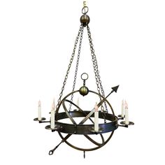 a chandelier with five candles hanging from it's center and four arms