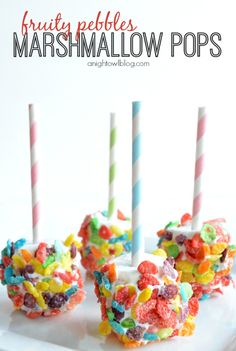 three marshmallow pops on a white plate