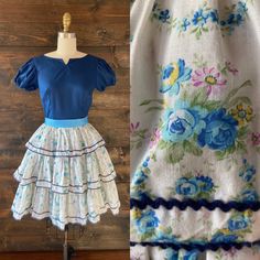 "- vintage 70's ruffled floral dress  - Navy bodice with notched neckline - Short puff sleeve with slits and ric rac trim, elastic cuff - 3-tier ruffled skirt in blue, yellow and purple floral - Ric rac trim allover - Back zip closure - Grosgrain ribbon belt in turquoise MEASUREMENTS Bust: 34\" Waist: 25\" Hip: free  Shoulder to waist: 15\" Waist to hem: 21\" Shoulder: 14\" Sleeve: 6\" Vintage labeled size: 8\" Best fits: Modern 2-4 LABEL Square Dance Dress Co FABRIC / FIBER 65% polyester / 35% Ruffle Floral Dress, Square Dance Dress, Square Dance Dresses, Square Dance, Notched Neckline, Short Puff Sleeve, Tiered Ruffle Skirt, Square Dancing