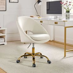 a white chair sitting in front of a computer desk