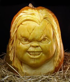 a pumpkin carved to look like a woman's face with hair and eyes on it