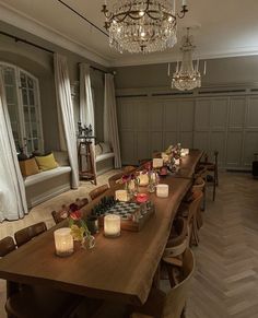 a long dining table with candles on it