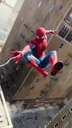 spider - man flying through the air over a city