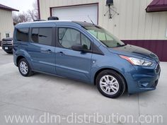 a blue van parked in front of a building