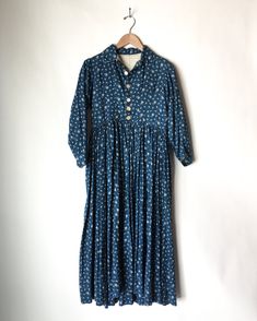 Rare calico indigo blue and white cotton prairie dress in great vintage condition. This dress is from the later part of the 1800’s/ early 1900’s and a lot of beautiful hand-stitching details are present. This is a wearable piece as well as a highly collectible and sought after garment. The gathering and pleating around the soar is incredible. The front has been opened to make it into a duster style. There's a little tear at the bottom of the dress in the back (see photo). MEASUREMENTS (flat) Arm Victorian Cotton Prairie Dress With Long Sleeves, Indigo Cotton Dress With Buttons, Victorian Cotton Prairie Dress, Victorian Cotton Prairie Dress For Daywear, Cotton Victorian Dress With Long Sleeves In Cottagecore Style, Cotton Victorian Dress With Buttons For Daywear, Cotton Long Sleeve Victorian Cottagecore Dress, Cottagecore Victorian Dress With Long Sleeves, Spring Cotton Regency Prairie Dress