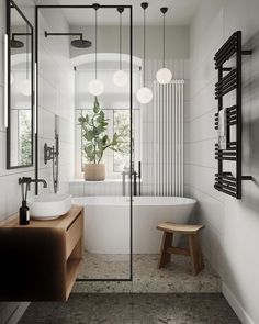 a bathroom with a sink, mirror and bathtub next to a plant in a vase