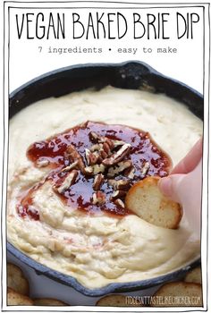 vegan baked brie dip in a cast iron skillet with toasted pecans