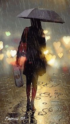 a woman walking in the rain with an umbrella