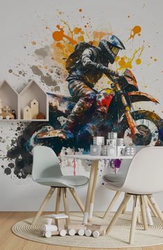 a painting of a motorcyclist is on the wall next to two chairs