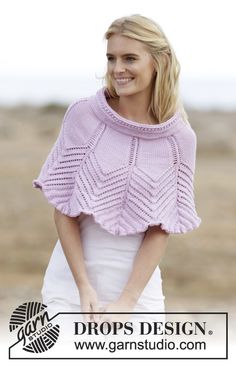 a woman wearing a pink knitted ponchy with an openwork design on it