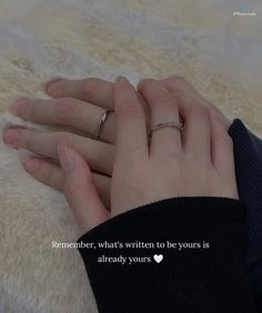 two hands holding each other on top of a fluffy white blanket with the words remember, what's written to be yours is already yours