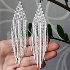 "White beaded earrings Seed bead earrings White silver chandelier earrings Shiny earrings Boho Evening earrings Length, beadwork part - 12.5 Centimeters (4.92\") Width -  3 Centimeters (1.18\") Materials: Czech glass beads Nylon Thread Silicone plugs  Stainless steel ear hooks .. ready to be given away! Contact me if you have any questions. I will be happy to answer :) Please note that due to lighting effects, monitor's brightness, contrast and other settings, there might be some slight differences in the color tone/shade of the web site's photo and the actual item. SHOP POLICY 1. If the package is damaged or your post tries to deliver you an empty package, refuse to receive it or file a claim, otherwise it can't be proven. 2. International customers are responsible for any import fees, ta Silver Beaded Earrings With Polished Beads As Gift, Silver Polished Beaded Earrings As Gift, Silver Polished Beaded Earrings For Gift, Elegant Silver Dangling Beads, Silver Sterling Beaded Earrings With Colorful Beads, Silver Chandelier Earrings With Faceted Beads, White Silver Beaded Drop Earrings, Silver Sterling Silver Earrings With Colorful Beads, Silver Beaded Drop Earrings With Dangling Beads