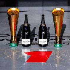 three bottles of champagne sitting next to each other on top of a star shaped floor