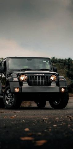 a black jeep is parked on the side of the road