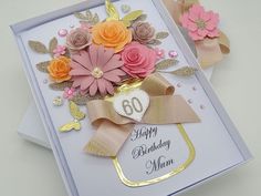 a birthday card with flowers on it and a gold ribbon around the edge that says 60