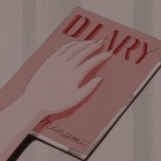 a woman's hand on top of a pink book with the word diary written in red