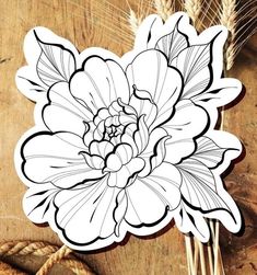 a sticker with a flower on it sitting next to some wheat and other items