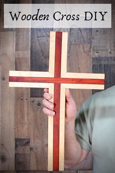 a person holding a wooden cross with the words wooden cross diy on it