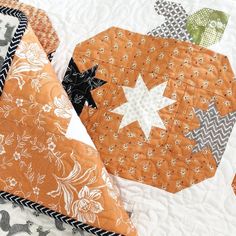 an orange and white quilt with stars on it