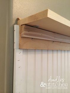 a wooden shelf is attached to the side of a wall with wood planks on it