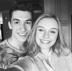 a young man and woman taking a selfie in black and white with the camera