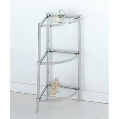 a bathroom corner shelf with soap bottles on it and a white wall behind the shelves