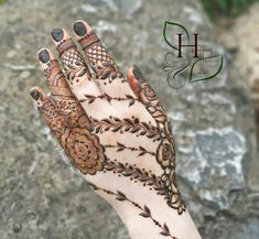 the hand is decorated with henna designs on it's fingers and hands, which are