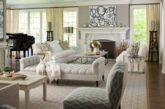 a living room filled with furniture and a piano