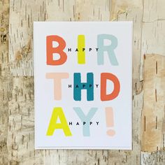 a card with the words, happy birthday on it in multicolored letters that spell out bird