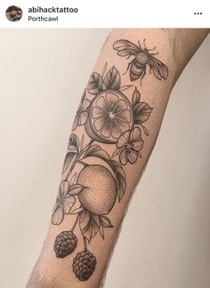 a person with a tattoo on their arm that has fruit and flowers all over it