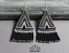 These gray beadwork gray earrings are made of high-quality Czech beads and strong synthetic thread. They are elegant, fashionable, and highly versatile, suitable for everyday wear. Features: Sterling silver components Color: gray, black, white Length (approximate): 6 cm (2.36 in) This item is currently in stock. You must be completely satisfied. If you find merchandise unsatisfactory for any reason, return it within 10 days and your money will be refunded without questions. These earrings in gol Gray Beaded Dangle Earrings, Handmade Gray Beaded Earrings For Gift, Handmade Gray Beaded Dangle Earrings, Handmade Gray Dangle Earrings, Handmade Gray Drop Earrings, Fringe Beaded Earrings, Beadwork Earrings, Gray Earrings, Native American Earrings