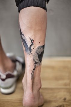 a person with a bird tattoo on their leg