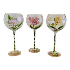 three wine glasses with flowers painted on them