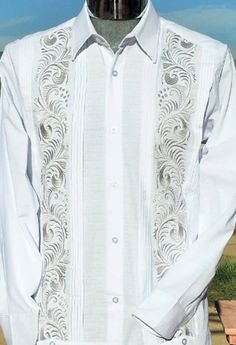 Introducing our White Linen Long Sleeve Guayabera, a masterpiece crafted with exquisite attention to detail and unparalleled elegance.  Made in Mexico, this guayabera features intricate double embroidery, Pleated along the embroidery in order to make it to stand out, in elegant silver thread, adding a touch of luxury to its classic design. It has a Pleated back panel. Handcrafted from linen, this garment is not only stylish but also breathable and comfortable, making it ideal for both casual and formal occasions.  The long sleeves offer versatility and sophistication, allowing you to effortlessly transition from day to night. Each stitch is meticulously placed to create a unique and elegant pattern.  Whether worn as a statement piece or as part of a refined ensemble, this Guayabera is sure Guayabera Wedding, Куклы American Girl, Linen Wedding, Guayabera Shirt, Silver Embroidery, Silver Silk, Wedding Linens, Wedding Shirts, Fine Linen