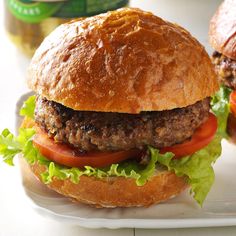 two hamburgers sitting on top of a white plate