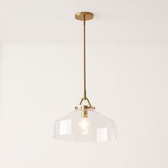 a light fixture hanging from the ceiling in a room with white walls and flooring