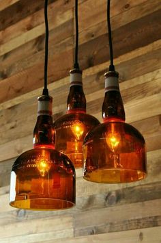 three light fixtures hanging from a wooden ceiling