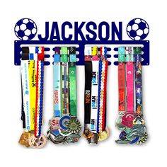 a group of medals hanging from the side of a metal sign that says, jackson