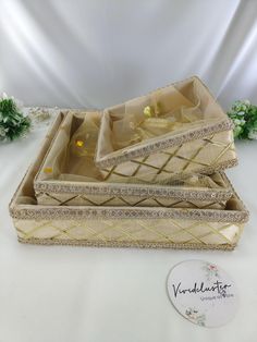 three gold jewelry boxes sitting next to each other