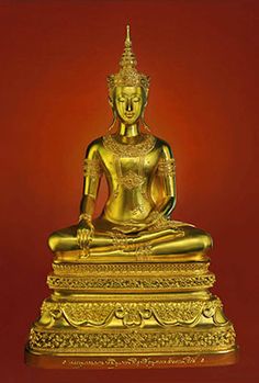 a golden buddha statue sitting on top of a table