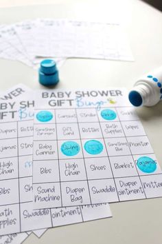 the baby shower game is sitting on top of a table next to markers and pens