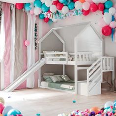 a room decorated with balloons, streamers and a house shaped bunk bed for children