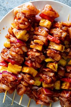 the skewers are covered with meat and vegetables on sticks, ready to be eaten