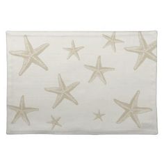 a placemat with starfishs on it in beige and white colors, set against a white background