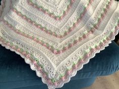 a crocheted blanket is sitting on a chair